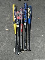 Group of 5 aluminum baseball bats showing front side with brand logos and color details on pavement background.