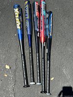Top down view of five aluminum baseball bats showing barrels and branding.