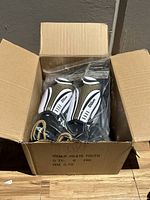 Cardboard box containing six pairs of Wilson youth shin guards in original packaging.