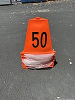 Single stack of bright orange plastic sideline marker cones labeled with 50 in black print.