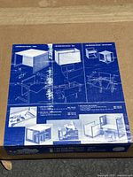 Close-up photo of the box top with detailed assembly diagrams showing the multifunctional kids furniture pieces (table, storage box, stool).
