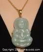 Front view of the carved jade Buddha pendant with gold-tone bail on a black string.