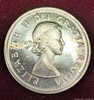 Obverse of the 1964 Canada 25 cent silver coin featuring Queen Elizabeth II profile and inscription.