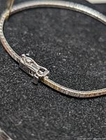 Close-up photo of the silver bracelet clasp and part of the chain