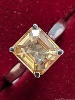 Close-up view of the square-cut moissanite set in sterling silver ring showing gemstone clarity and setting.