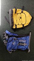 Yellow and blue dry-bag backpacks displayed