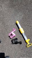 Overall view of NRS bilge pump, pink and black Canpanion holders on pavement