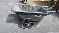 Side view showing Rubbermaid logo, one plastic wheel without tire
