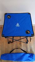 Top view of blue folding camping table with cup holders