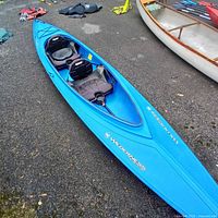 Full view of blue Wilderness Systems tandem kayak on ground