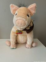 Front view of Babe plush pig showing overall condition, tag and scarf with mice