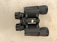 Top view of binoculars showing leatherette covering and overall wear