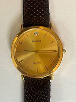 Front view of Birks gold-tone watch face and strap