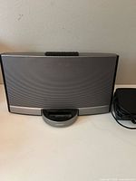 Front view of Bose SoundDock speaker dock and power supply
