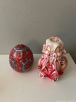 Egg candle and carved pillar candle side by side