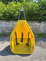 Front view of yellow Cannondale double bike trailer shell with tow arm attached