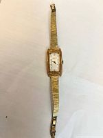 Full view of Caravelle rectangular gold-tone wristwatch with expansion bracelet