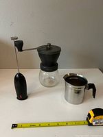 Grinder, frother, pitcher with tape measure for scale