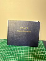 Front cover showing blue hardcover with gold title