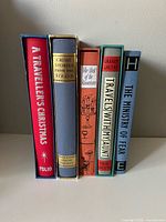 Spines of all five Folio Society books showing titles and slipcases