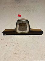 Front view of clock showing dial, case design