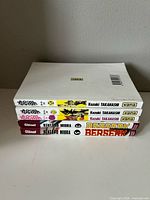 Spines stacked showing publisher logos, volumes