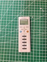 Front view of iClicker 2 remote on cutting mat, LCD reads READY