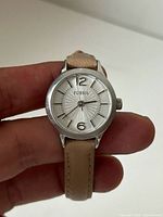 Front view of Fossil wristwatch showing dial details and leather strap