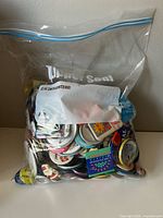 Full view of clear plastic bag packed with buttons