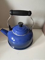 Front angled view of blue Le Creuset kettle showing exterior color and shape