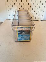 Front view of box showing top card (Frillish) and stack thickness