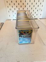 Top angled view of clear box showing front card and stack