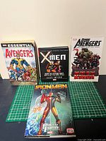 Front covers of the four Marvel paperback graphic novels laid out on cutting mat