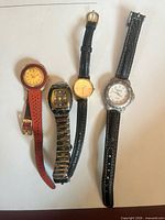 All four wristwatches aligned side by side