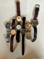 Front view of all seven watches showing dials, straps and bracelets