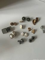 All eleven pairs of clip-on earrings laid out