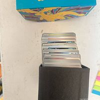 Top view of stack of Pokémon cards in black tray