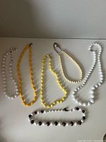 All six necklaces laid out to show colours and styles