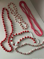 All five necklaces laid out to show colors, shapes and lengths