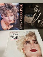 Front covers of Angel maxi-single, Like a Virgin LP and Who's That Girl LP