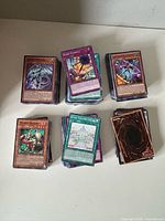 Six stacks of assorted trading cards on tabletop