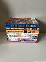 Stack of all eight manga volumes showing spines and volume numbers