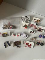 Overall view of earrings on playing cards and bag of studs