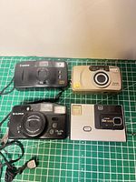 Front view of four cameras showing brands and lens areas