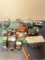 Overall view of SLRs, rangefinder, point-and-shoots, flashes and Sony camcorder