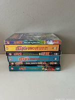 Stacked view of five of the Naruto DVDs showing spine titles and disc counts