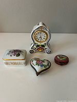 Group shot showing three Limoges pill boxes and Delft clock