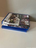 Three stacked PS5 game cases showing spines including Gori: Cuddly Carnage and Fallen Legion collection