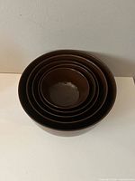 Five brown Rosti nesting bowls stacked