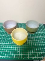 Three coloured footed bowls top view